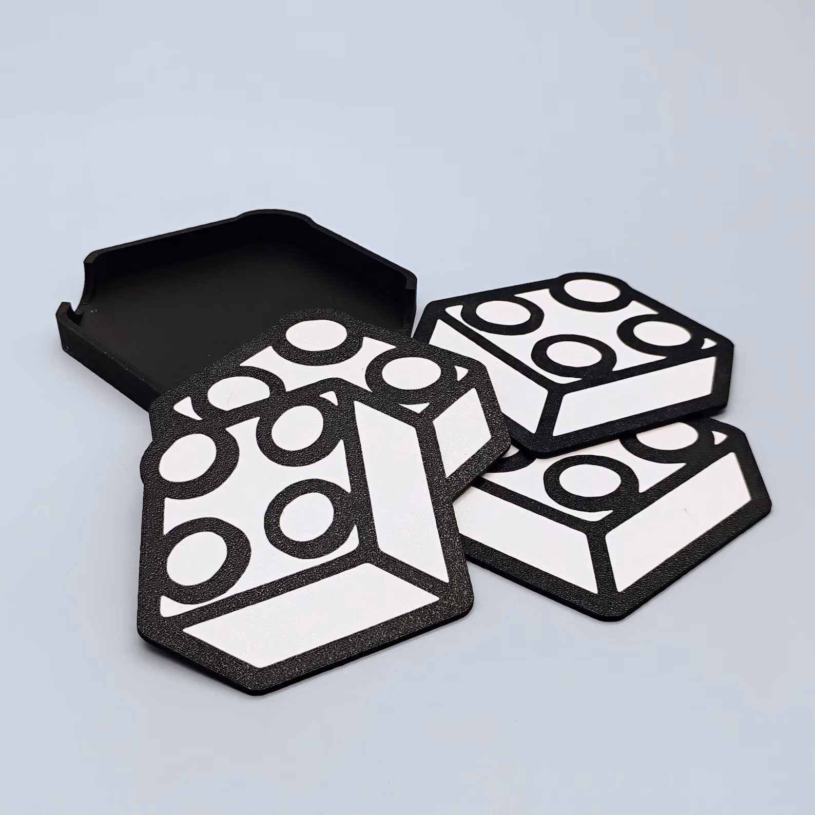 Black and white brick-themed coaster set with matching holder.