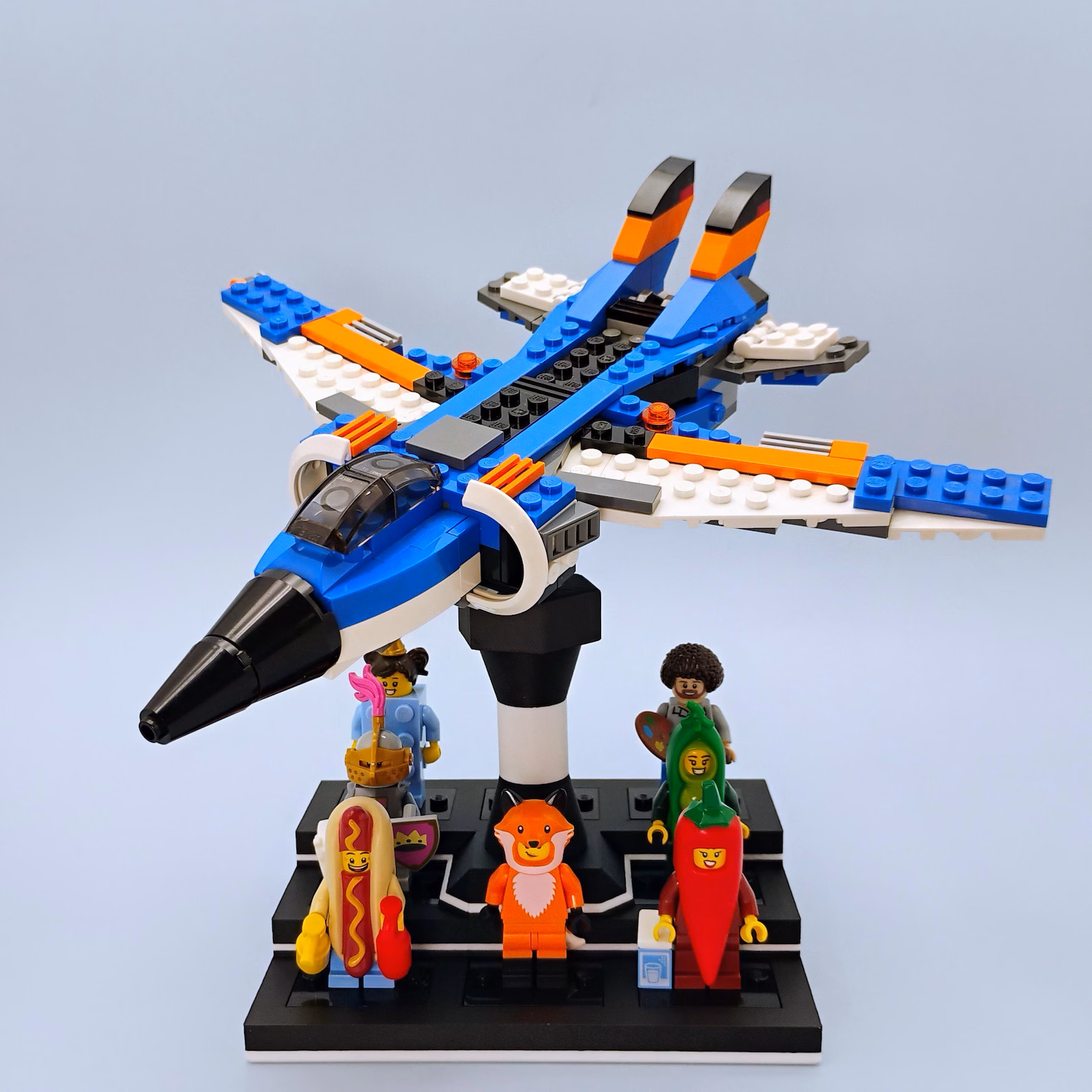 Minifig display stand holding a LEGO-style ship elevated above a platform of minifigures.