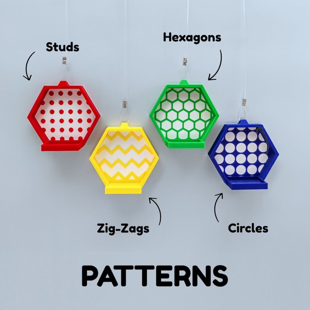 Color lineup showing pattern options for the hexagon display faces with labels: studs, hexagons, zig-zags, circles. Red, yellow, green, blue, and black examples shown.